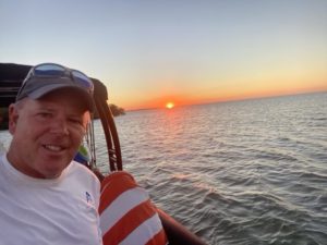 a person standing next to a body of water