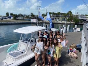 a group of people standing in front of a boat